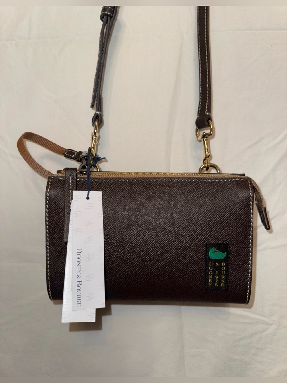 Dooney & Bourke brown Pebbled Small Alpine Janine Crossbody in the color Sky.